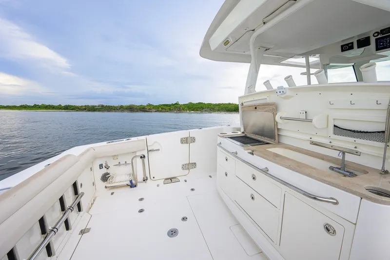 Slide: The Image of 2018 Boston Whaler 380 Outrage boat interior with kitchenette and ocean view. - 57