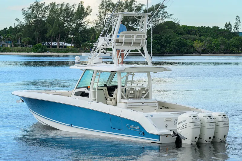 Slide: The Image of 2018 Boston Whaler 380 Outrage boat with triple Mercury engines on calm water. - 5