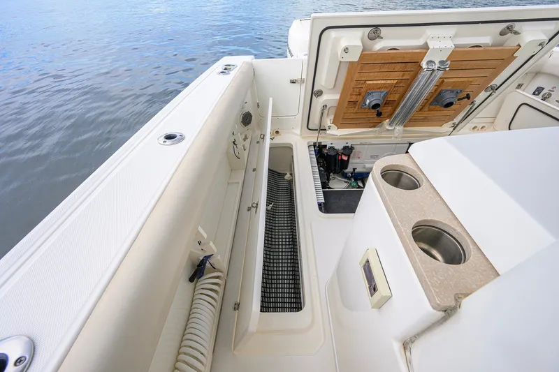 Slide: The Image of 2018 Boston Whaler 380 Outrage boat interior with storage compartments and cup holders. - 68