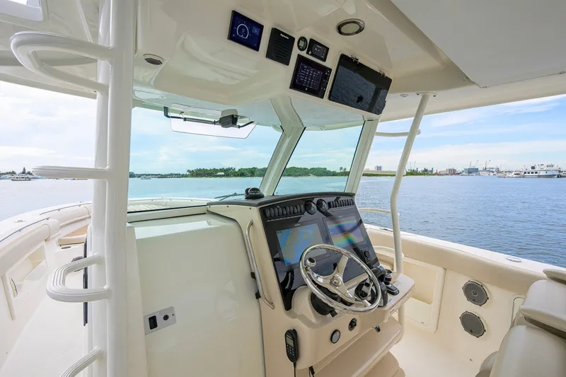 Slide: The Image of 2018 Boston Whaler 380 Outrage helm with advanced navigation system on calm waters. - 12