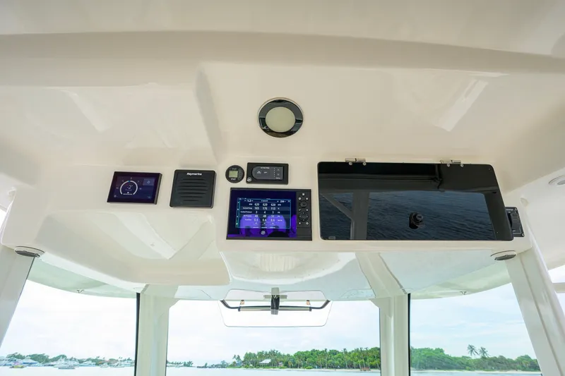 Slide: The Image of Interior dashboard of a 2018 Boston Whaler 380 Outrage boat with electronic controls. - 16