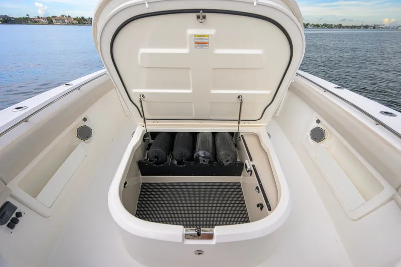 Slide: The Image of 2018 Boston Whaler 380 Outrage boat storage compartment open, revealing interior space. - 24