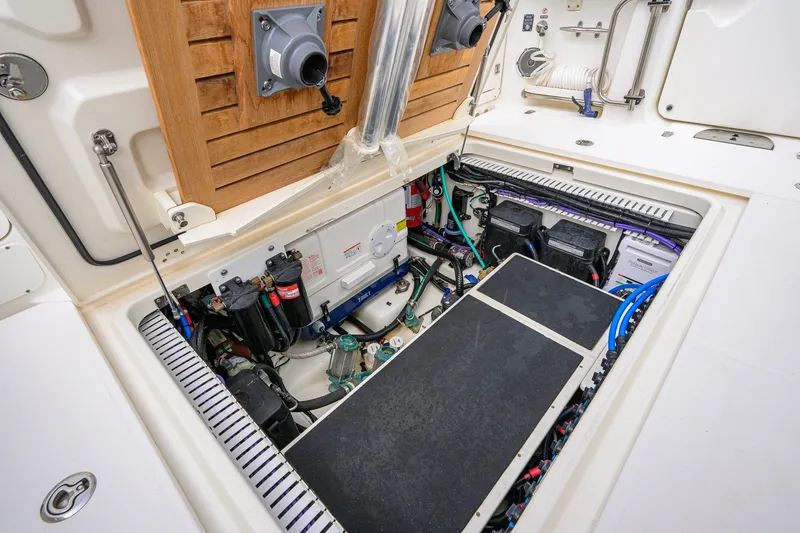 Slide: The Image of Engine compartment of 2018 Boston Whaler 380 Outrage, showcasing mechanical components and wiring. - 71