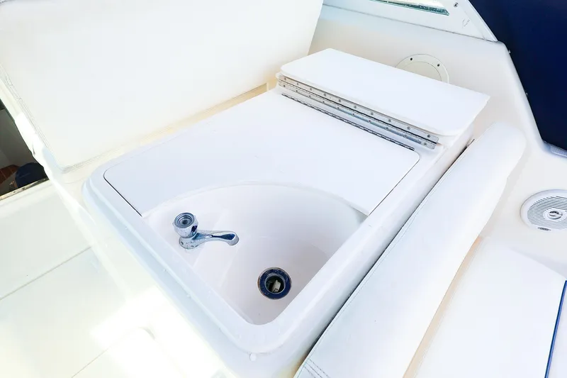 Slide: The Image of 2003 Tiara Yachts 2900 Coronet sink area with faucet and white seating. - 20
