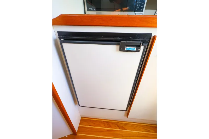 Slide: The Image of Compact fridge in 2003 Tiara Yachts 2900 Coronet interior with wooden accents. - 26