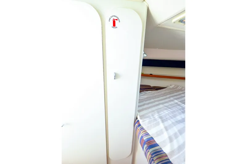 Slide: The Image of Interior cabin of 2003 Tiara Yachts 2900 Coronet with bed and fire extinguisher sign. - 33