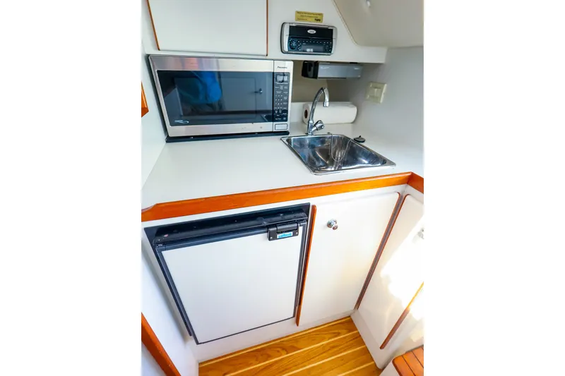Slide: The Image of Compact galley in 2003 Tiara Yachts 2900 Coronet with microwave, sink, and mini-fridge. - 25