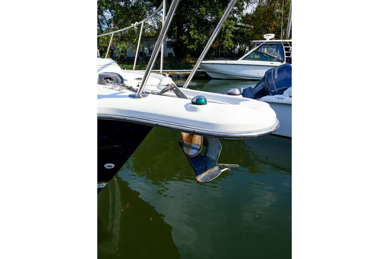 Slide: The Image of 2003 Tiara Yachts 2900 Coronet anchored in calm waters, showcasing its sleek design. - 7