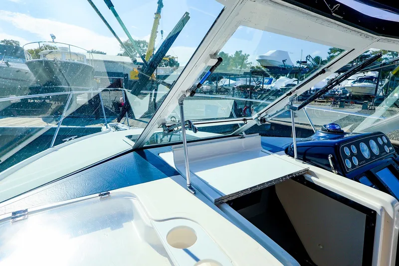 Slide: The Image of 2003 Tiara Yachts 2900 Coronet cockpit view with dashboard and marina background. - 13