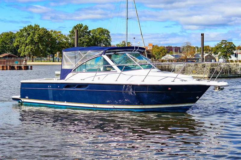 Slide: The Image of 2003 Tiara Yachts 2900 Coronet in water, blue hull, scenic background. - 3