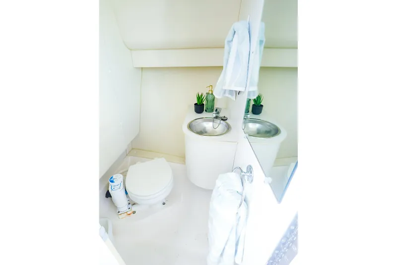 Slide: The Image of 2003 Tiara Yachts 2900 Coronet bathroom with toilet, sink, and mirror. - 35