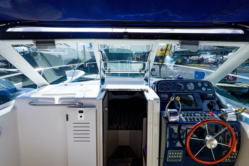 Slide: The Image of 2003 Tiara Yachts 2900 Coronet cockpit with steering wheel and control panel. - 8
