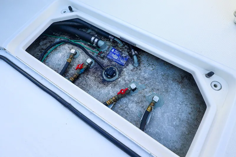 Slide: The Image of Engine compartment of a 2003 Tiara Yachts 2900 Coronet with visible hoses and fittings. - 30