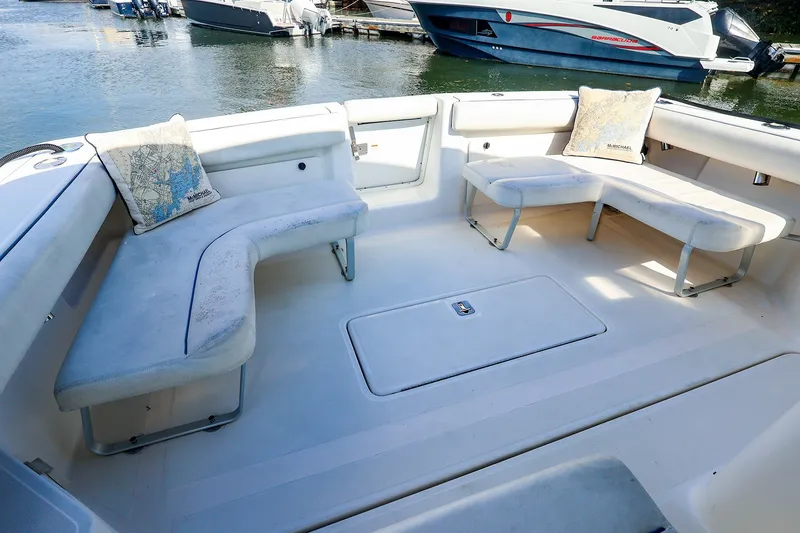 Slide: The Image of Spacious seating area on a 2003 Tiara Yachts 2900 Coronet, docked by the water. - 16