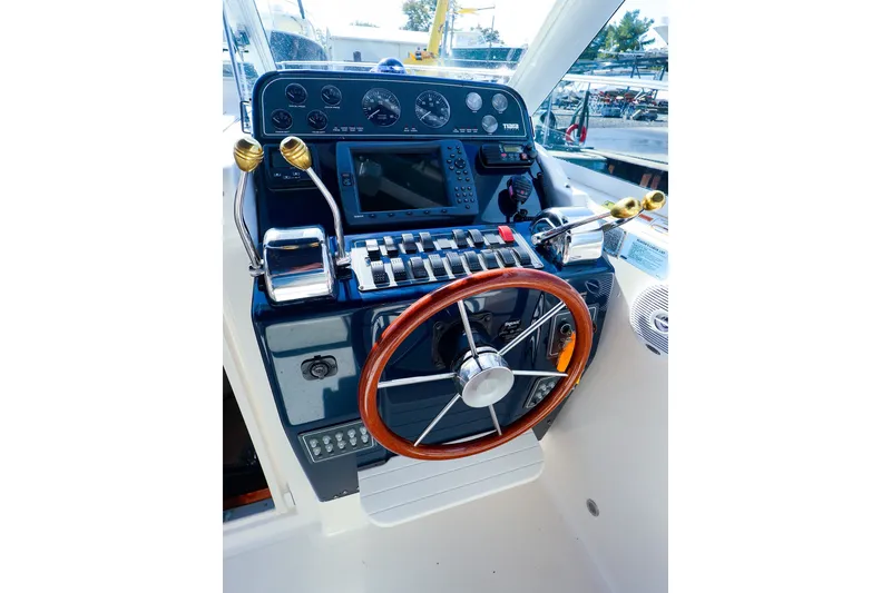 Slide: The Image of 2003 Tiara Yachts 2900 Coronet helm with wooden steering wheel and control panel. - 9