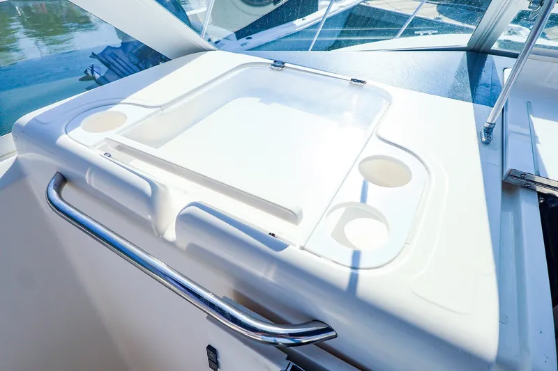 Slide: The Image of 2003 Tiara Yachts 2900 Coronet cockpit detail with cup holders and stainless steel railing. - 18