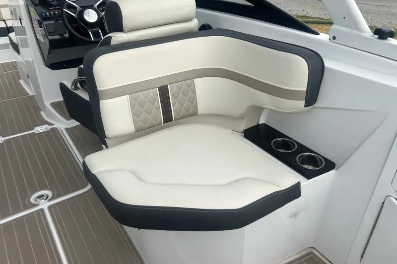 Slide: The Image of Luxury seating on 2023 Monterey M6 boat with cup holders and elegant design. - 11