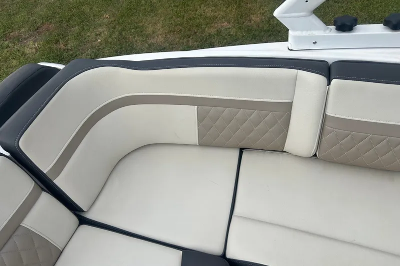 Slide: The Image of Luxurious seating in a 2023 Monterey M6 boat, featuring elegant quilted upholstery. - 13