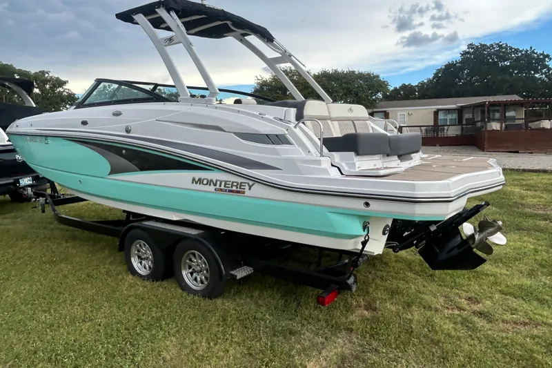 Slide: The Image of 2023 Monterey M6 boat on trailer, featuring sleek design and modern amenities. - 2