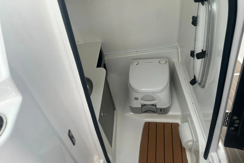 Slide: The Image of 2023 Monterey M6 boat bathroom with compact toilet and wooden floor mat. - 18