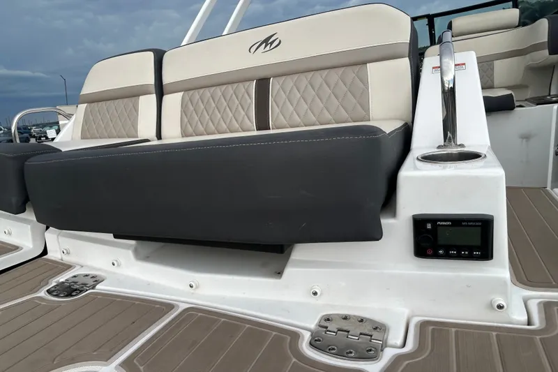 Slide: The Image of 2023 Monterey M6 boat seating with luxurious upholstery and integrated audio controls. - 7