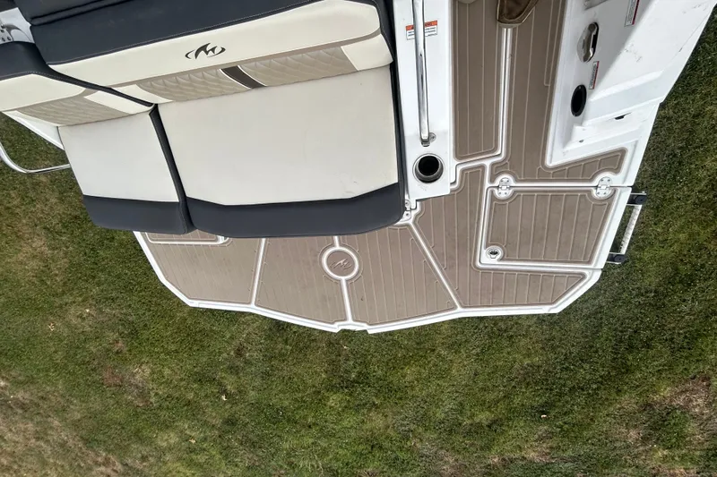 Slide: The Image of 2023 Monterey M6 boat deck with cushioned seating on grassy surface. - 10