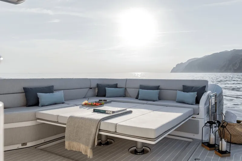 Slide: The Image of Luxurious seating area on an Azimut Verve 48 yacht with ocean view and stylish cushions. - 14