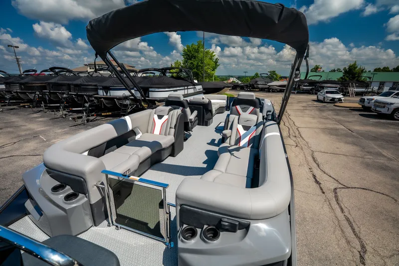 Slide: The Image of 2026 Evotti 725QL pontoon boat with spacious seating and canopy in a dealership lot. - 53