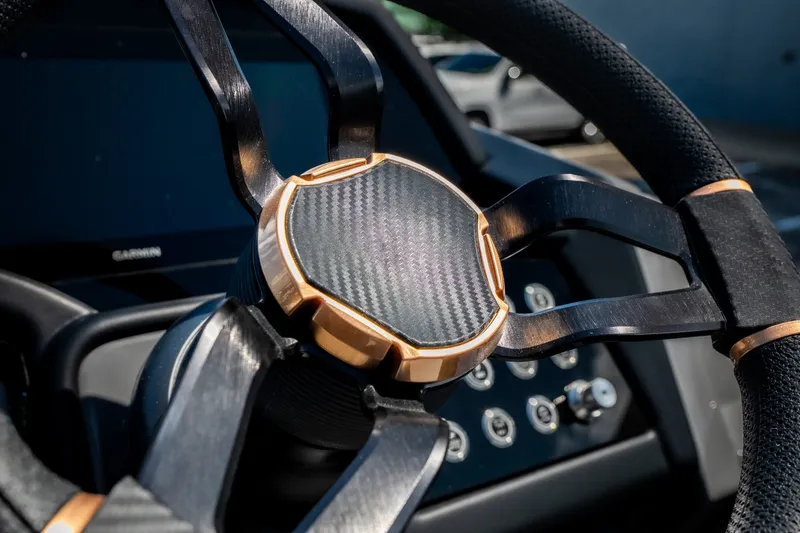 Slide: The Image of Steering wheel of 2026 Evotti 725QL with carbon fiber and metallic accents. - 26