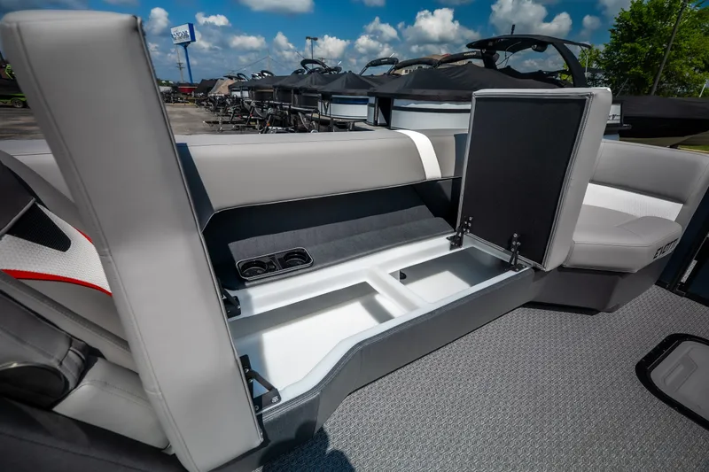 Slide: The Image of Evotti 725QL 2026 boat interior with open storage compartment and cup holders. - 38