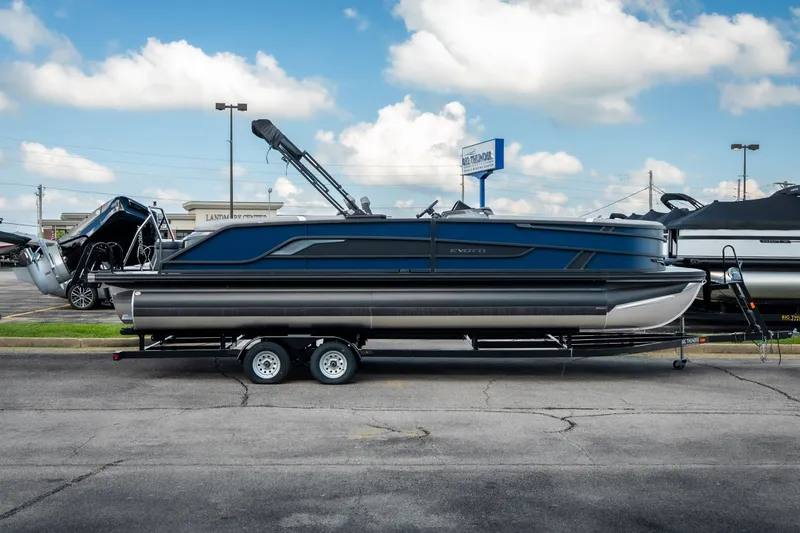 Slide: The Image of 2026 Evotti 725QL pontoon boat on trailer, parked in dealership lot under blue sky. - 2
