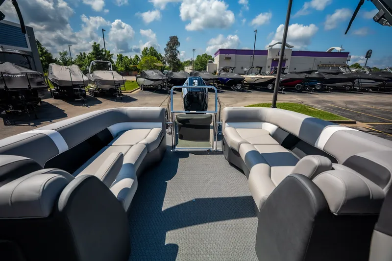 Slide: The Image of Luxurious 2026 Evotti 725QL pontoon boat interior with plush seating, parked outdoors. - 44