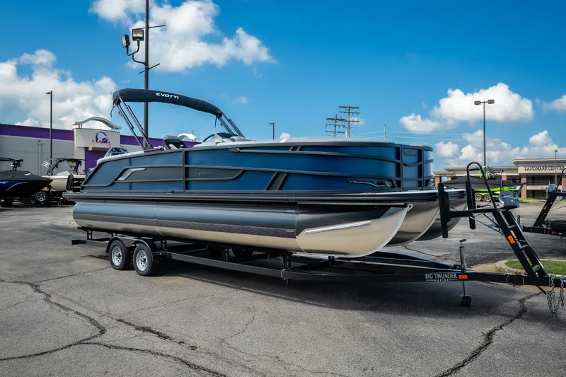 Slide: The Image of 2026 Evotti 725QL pontoon boat on trailer in parking lot under blue sky. - 5