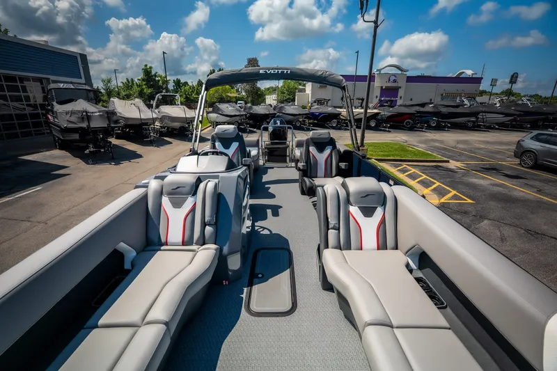 Slide: The Image of Luxurious 2026 Evotti 725QL pontoon boat with plush seating, parked outdoors under a blue sky. - 40