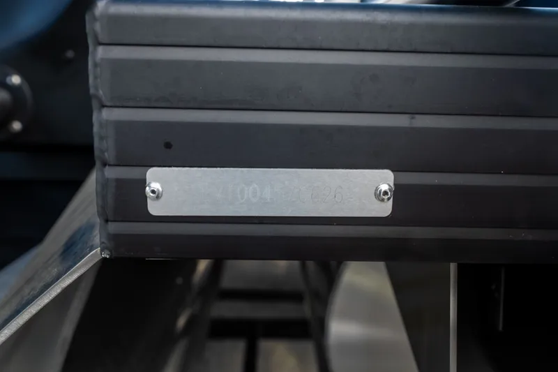 Slide: The Image of Close-up of Evotti 725QL 2026 model serial number plate on black metal surface. - 3