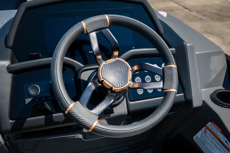 Slide: The Image of Steering wheel of 2026 Evotti 725QL with modern dashboard controls. - 24