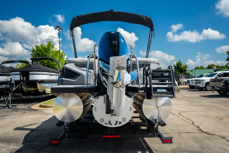 Slide: The Image of 2026 Evotti 725QL pontoon boat with sleek design, parked outdoors under a clear blue sky. - 13