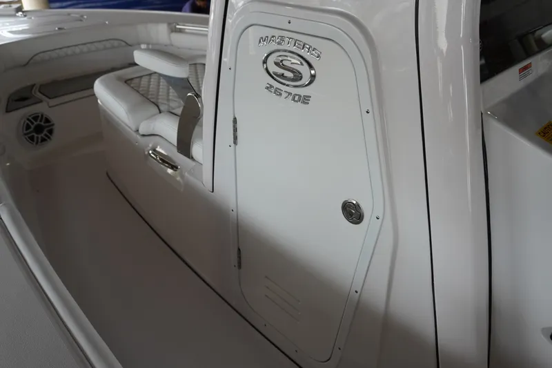 Slide: The Image of 2027 Sportsman Masters 267OE Bay Boat interior with seating and storage compartment. - 19