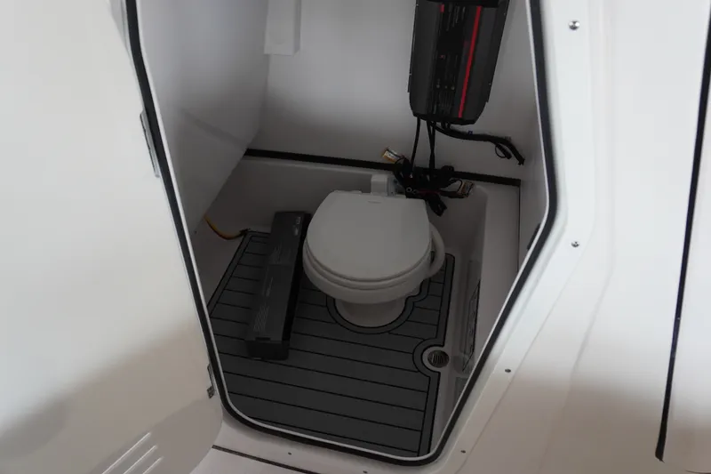 Slide: The Image of Interior of 2027 Sportsman Masters 267OE Bay Boat featuring compact marine toilet. - 20