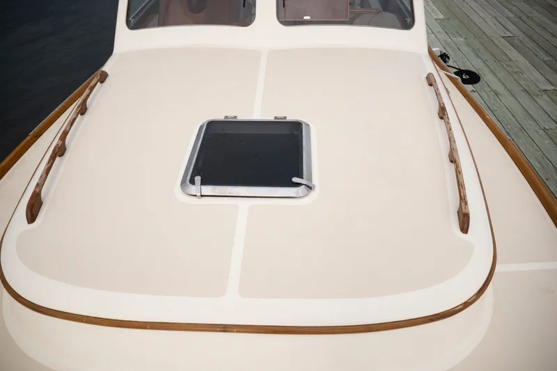 Slide: The Image of 2009 Hinckley Picnic Boat 37 MKIII deck with hatch and wooden rails. - 24