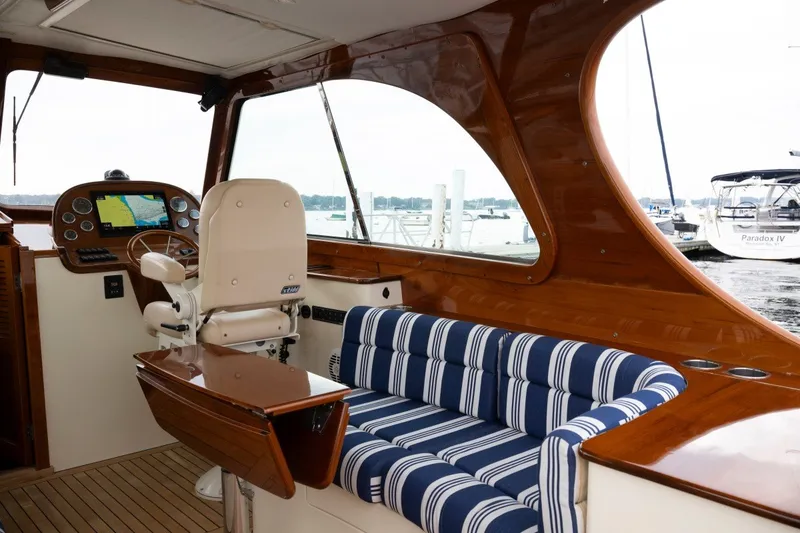 Slide: The Image of Elegant interior of 2009 Hinckley Picnic Boat 37 MKIII with striped seating and navigation console. - 23