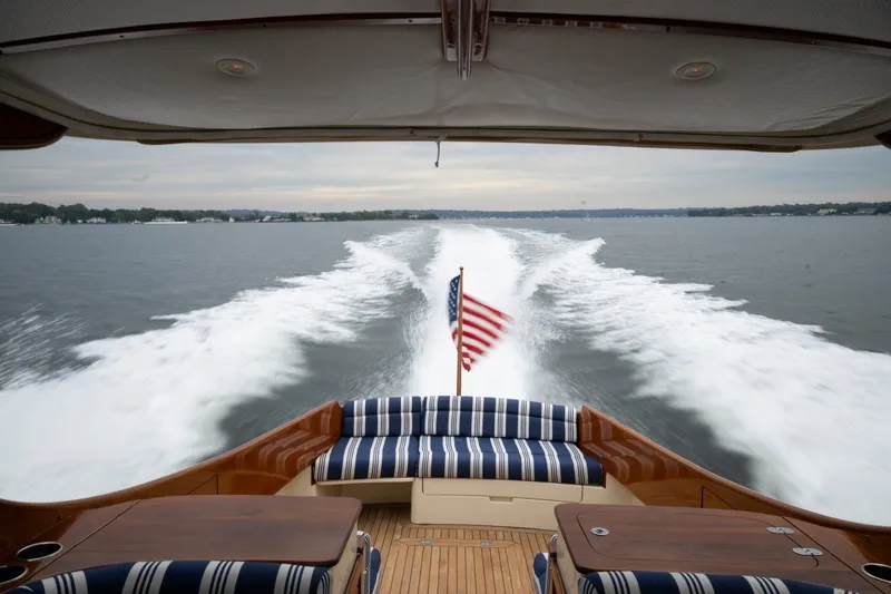 Slide: The Image of Hinckley Picnic Boat 37 MKIII cruising, American flag waving, 2009 model, scenic water view. - 20