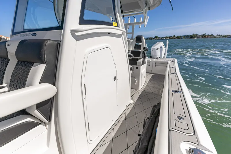 Slide: The Image of 2024 Tidewater 3100 Carolina Bay boat on water, showcasing sleek design and spacious deck. - 41