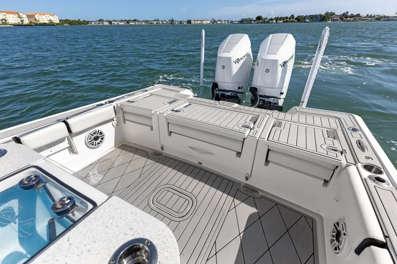 Slide: The Image of 2024 Tidewater 3100 Carolina Bay boat with dual engines on open water. - 27