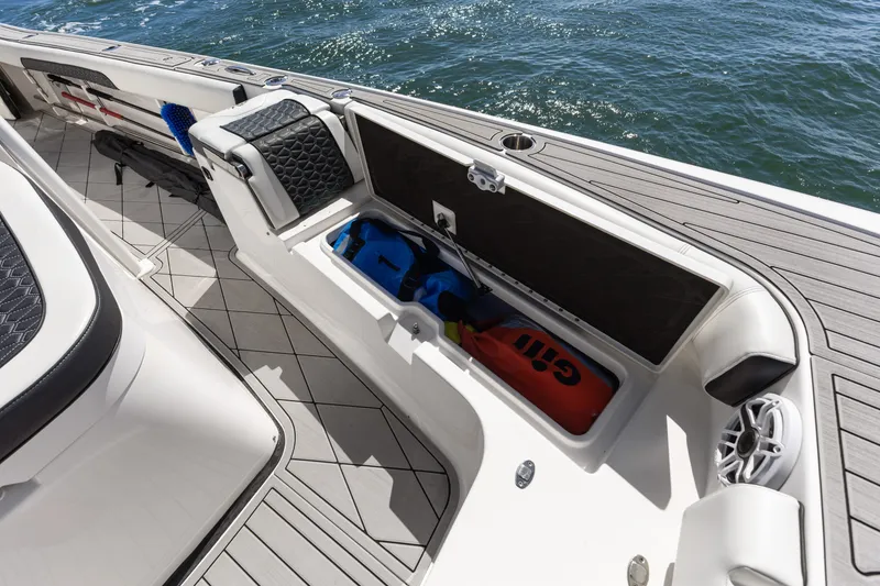 Slide: The Image of 2024 Tidewater 3100 Carolina Bay boat storage compartment with gear, on a sunny day. - 45