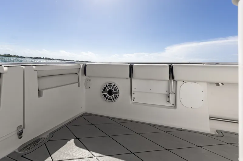 Slide: The Image of 2024 Tidewater 3100 Carolina Bay boat interior with speaker, under clear blue sky. - 31