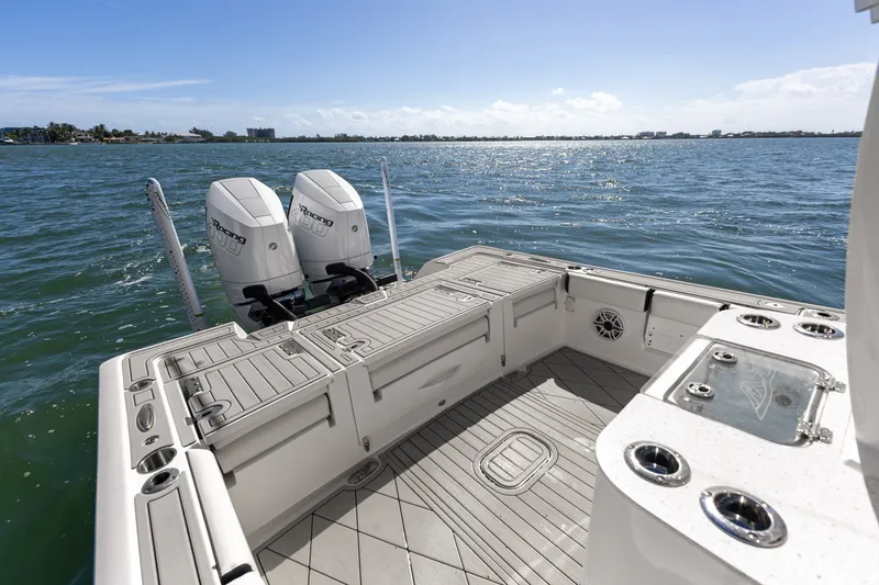 Slide: The Image of 2024 Tidewater 3100 Carolina Bay boat with twin engines on open water. - 30