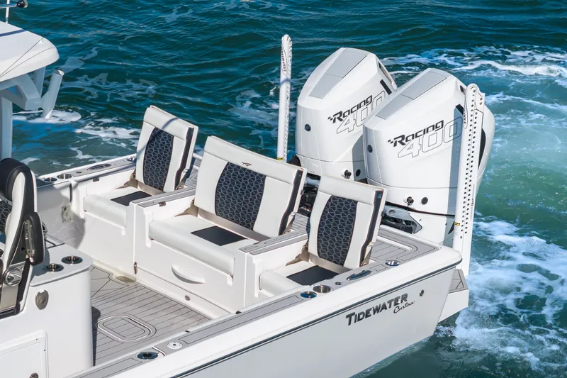 Slide: The Image of 2024 Tidewater 3100 Carolina Bay boat with dual Racing 400 engines on the water. - 28