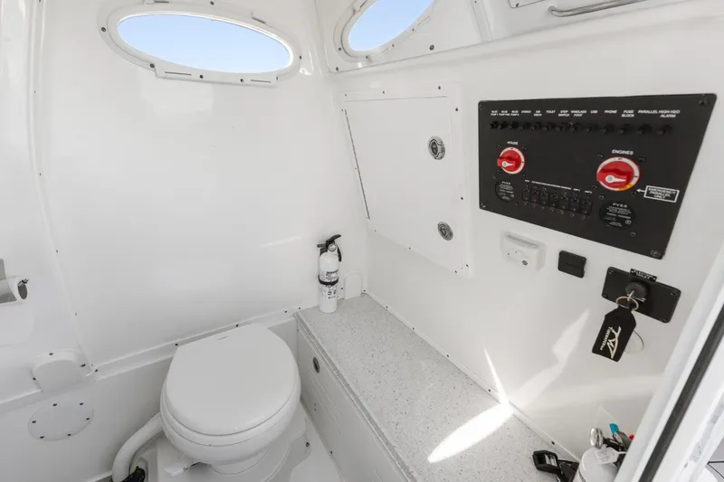 Slide: The Image of 2024 Tidewater 3100 Carolina Bay boat interior with toilet and control panel. - 56