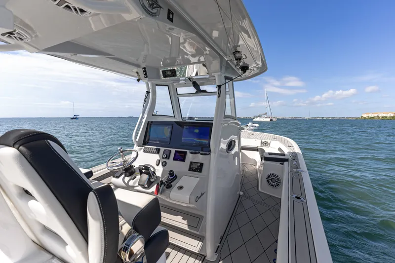 Slide: The Image of 2024 Tidewater 3100 Carolina Bay boat interior with advanced navigation system on open water. - 42